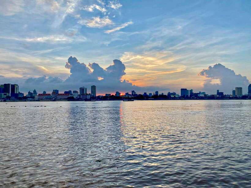 Phnom Penh: Mekong River Sunset Cruise and Tuk Tuk Ride - Phnom Penh lights up from the water