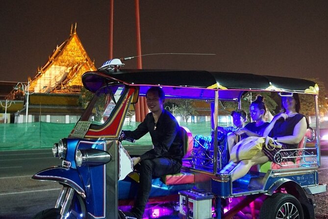 Private Bangkok Night City Tour by Tuk-Tuk with Thai Food - Wat Arun lit up beside the river